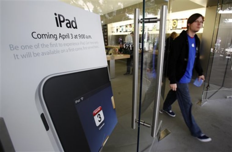 An iPad advertisement is seen at an Apple Store in Palo Alto, Calif. A whole lot of people are willing to plunk down their money for an iPad, sight unseen, hoping it will turn out to be the missing link in their digital lives. 